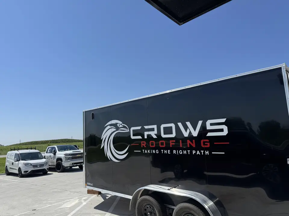 Crows Roofing branded trailer and work trucks